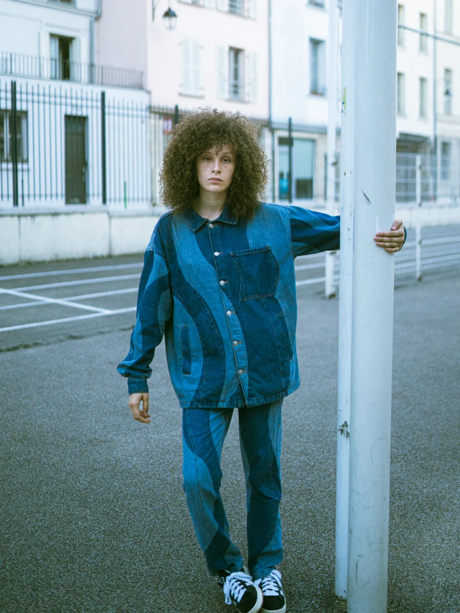 Portrait debout sur un terrain de sport, tenue en jean